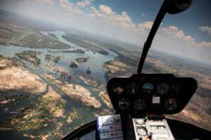 Victoria Falls Safari, Hiking, and Drone Views 2 Aerial view of a Africa river winding through dense rainforest, seen from a helicopter above.
