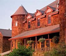 Hotel with shrubs in front of building.