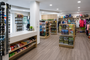 Havasu Falls Camping & Hiking Vacation 8 Bright visitor center gift shop featuring outdoor apparel, hiking accessories, souvenirs, maps, snacks, water bottles, and travel essentials for park visitors.