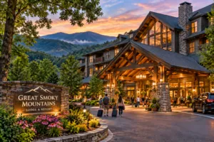 Great Smokey Mountains, Camping, Vacation 10 Guests walking with luggage toward a rustic mountain lodge entrance surrounded by forested Great Smoky Mountains at sunset.