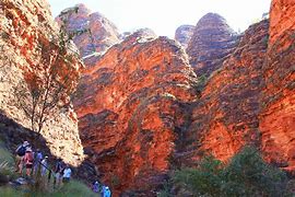 people hiking in the desert at Ayers rock Australia