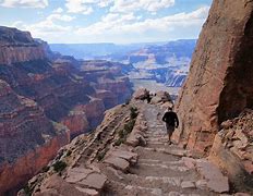 person walking downstairs on a trail 