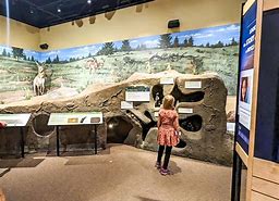 Bryce Canyon Utah Vacation 8 People at a museum looking at artifacts.