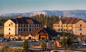 Bryce Canyon Utah Vacation 6 Hotel at a canyon with a forest on a clear blue-sky day.