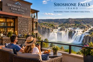 Couple relaxing on a hotel terrace overlooking Shoshone Falls and the dramatic Snake River Canyon landscape in Idaho.