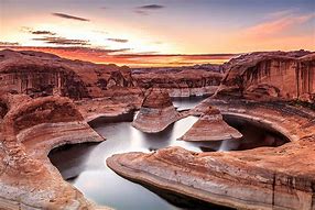 Canyon with steep cliffs and a river that flows through om a sunset afternoon.