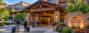 Explore New York’s Scenic Finger Lakes Region 4 Travelers with luggage walking toward the entrance of a scenic canyon lodge surrounded by towering cliffs and landscaped grounds.
