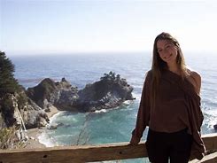 woman standing on balcony at the ocean