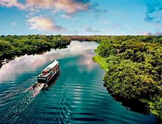 cruise ship on the Amazon River with rainforest