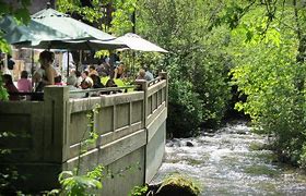 people at a restaurant near a river