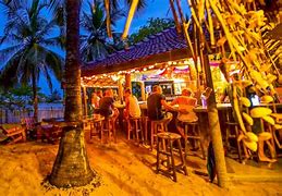 people at night at the beach bar