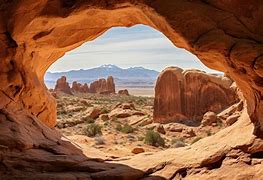 from a cave looking at steep walled cliffs