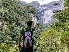 hiker with backpack hiking in the rainforest