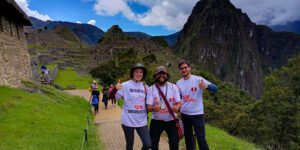 Exploring Cusco, Peru: Gateway to Ancient Ruins and Adventure 2 Hikers standing on a trail overlooking Machu Picchu, Peru, with panoramic views of the ancient Incan city and surrounding mountains.