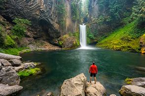 person standing looking at the waterfalls