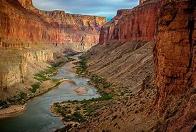 canyon with steep walls with a river flowing through the center
