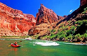 canoeing on a river in a canyon with steep cliffs