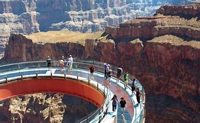 grand Canyon with people satandingb on platform looking at the canyon with steep cliffs