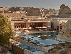 Cataract Canyon Utah Adventure Tours 7 pool at a hotel with lounge chairs and mountains in the background