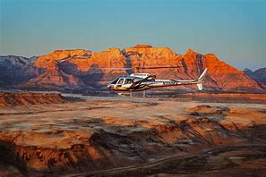 Capitol Reef National Park Guided Tours 4 helicopter flying at a canyon with steep cliffs