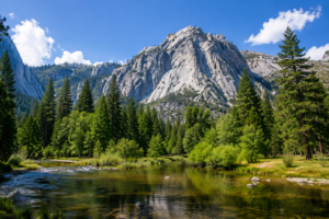 Kings Canyon, California, Camping And Hiking 2 Scenic view of Kings Canyon National Park featuring a crystal-clear river, towering granite mountains, lush pine forests, and a bright blue sky in California's Sierra Nevada.
