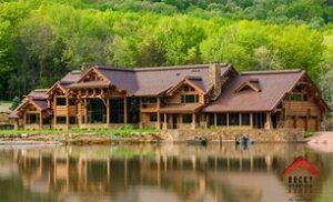 Rocky Mountain National Park Camping & Hiking 6 Hotel with a lake in front and a forest in the background.