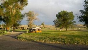 Bruneau Sand Dunes, Idaho, Camping & Hiking 4 Camping tent in a field with trees on a cloudy day.