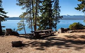 Top 10 Camping Destinations For 2025 8 Picnic table next to a lake in a forest