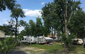 Campers in a forest in Oregon on a partly cloudy day.