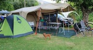 camping tent and a dog with table and chairs