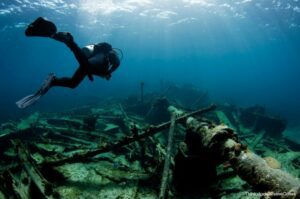 Scuba diver exploring the ocean above debris from a shipwreck at Corolla Beach, NC.