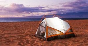 camping tent at a beach next to the ocean