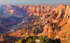 Explore the Best West Canyon Adventures: Top 15 Camping & Hiking Destinations ?⛺ 14 Canyon with steep walls and vegetation with a river.