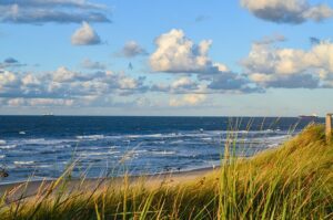 ? Hidden Beach Camping Escapes in the Carolinas You Haven’t Heard Of ?️? 2 Beach and the ocean on a partly cloudy day.