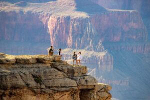 people standing at the top of a canyon