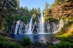 waterfalls in a forest and lake