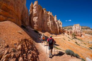 hikers with backpacks in a hiking trail and rock formations