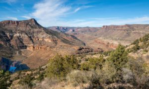 ?️ 5 Stunning Canyon Campsites You’ve Probably Never Heard of 5 canyon with steep cliffs and vegetation and partly cloudy sky