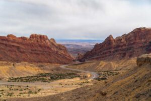 ?️ 5 Stunning Canyon Campsites You’ve Probably Never Heard of 1 canyon with steep cliffs and a paved road going through on a cloudy day