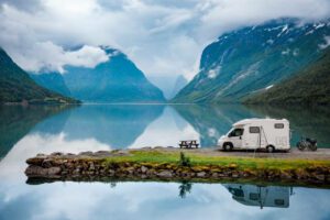 camper next to lake and mountains