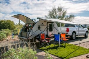 camper with chairs and a sunroof