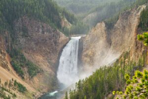waterfalls with steep cliffs and forest