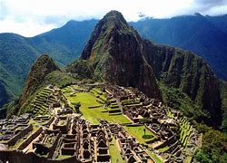 City on a mountain with ancient ruin buildings and mountains