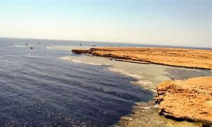 Ras Mohammed National Park: Egypt’s Underwater Gem 1 An island in the ocean with a rocky shoreline.