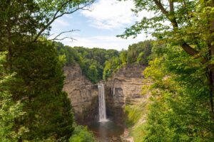 Watkins Glen State Park, NY: A Gorge-ous Waterfall Wonderland✨?️ 1 Waterfalls with steep rock walls in a forest on a cloudy day.