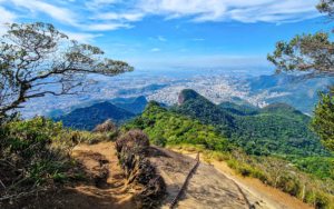 Panoramic view from Tijuca National Park overlooking lush rainforest mountains and Rio de Janeiro, Brazil.