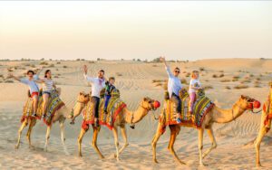 Several people on camels in the desert at Egypt safari