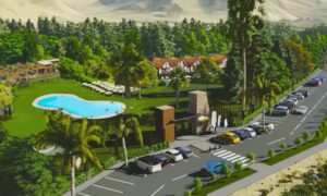 Resort with a pool and cars with buildings and a forest.