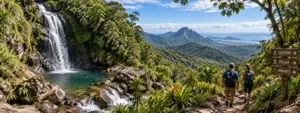 Serra Do Mar Glamping Retreat: Mountain Views And Rainforest Trails 4 Hikers exploring a lush Serra do Mar mountain trail beside a cascading waterfall and natural pool surrounded by Brazil’s Atlantic Forest.