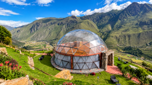 Andean Mountain Yurt, Chinchero: Authentic Highlands Experience In A Cozy Yurt 4 Transparent geodesic glamping dome overlooking green Andean mountains and highland farmland near Chinchero, Peru.